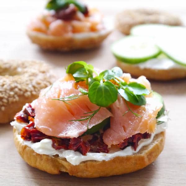 Pastry covered with yogurt-cheese mixture, sun-dried tomatoes and smoked salmon, decorated with fresh herbs.