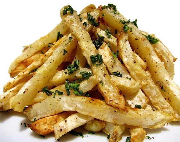 Crispy vegetable fries sprinkled with salt and fresh herbs.