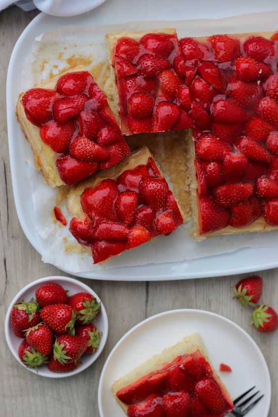 Geschnittenes Dessert mit frischen Erdbeeren und Puddingcreme.
