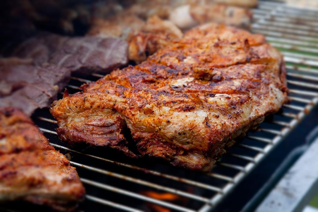 Seasoned pork belly prepared on the grill.