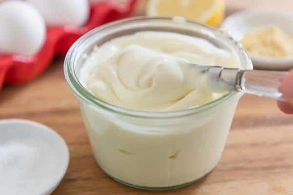 Cottage cheese mayonnaise in a jar, scooped with a spoon.