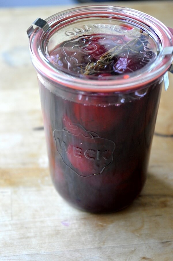 Pickled plums in a jar.