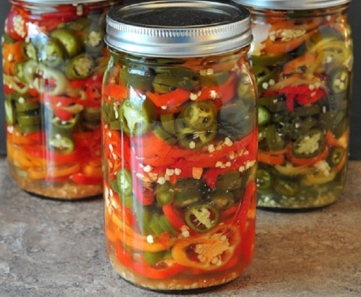 Pickled hot peppers in mason jars.