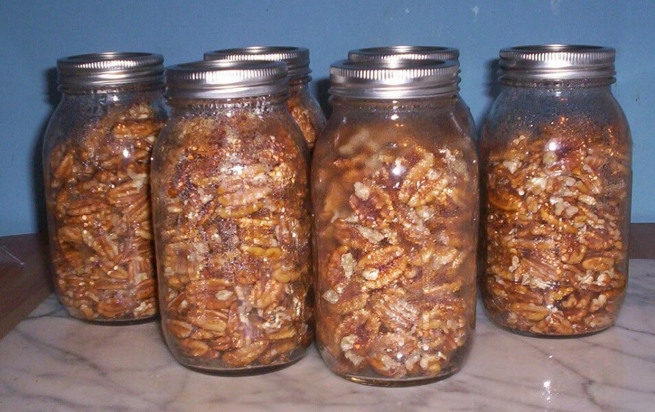 Several mason jars with walnuts.