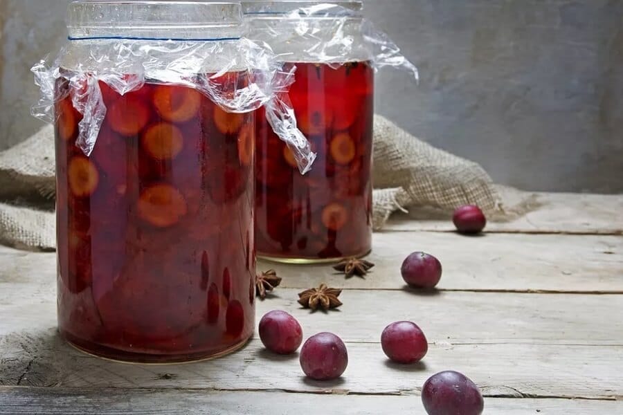 Pickled plums in jars.