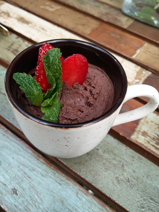 avocado mousse with chocolate and strawberries with mint garnish