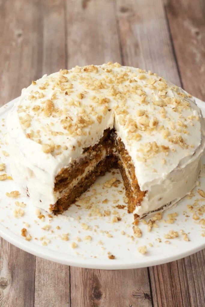 carrot cake with filling and frosting made of mascarpone cream with nuts