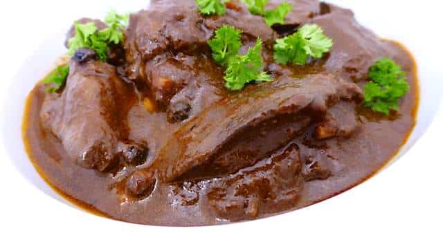 Beef liver with sauce and herbs.