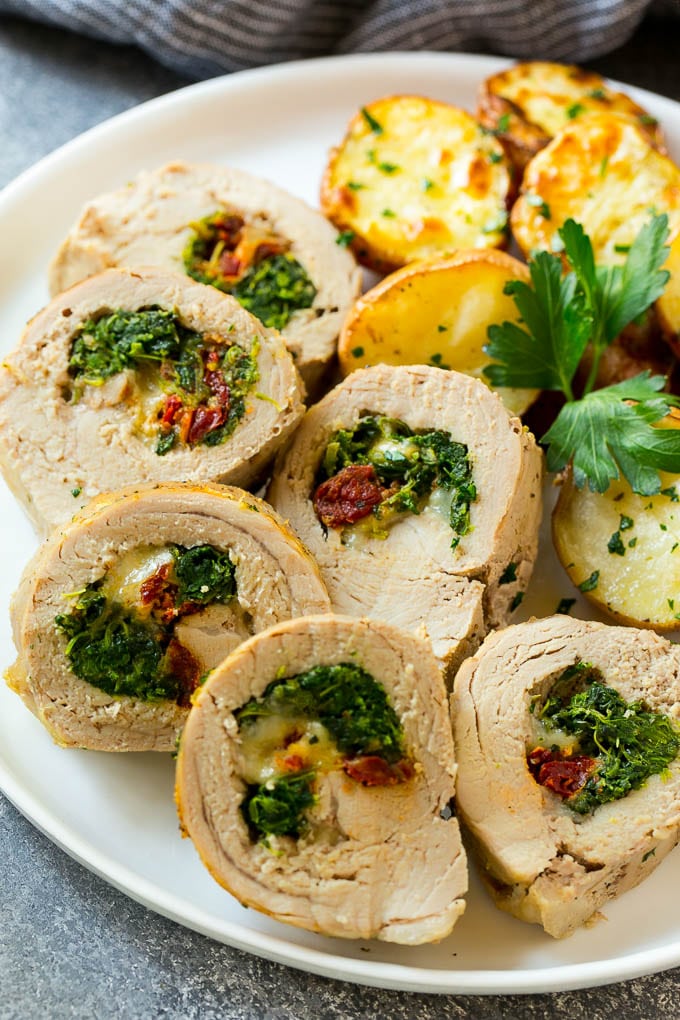 Pork tenderloin rolls filled with spinach, cheese and tomatoes.