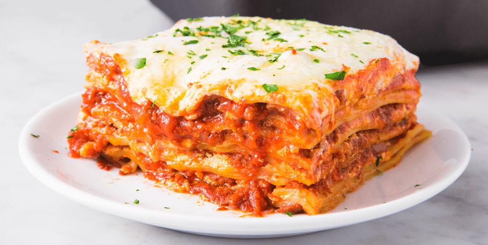 A portion of lasagna with bolognese sauce on a plate