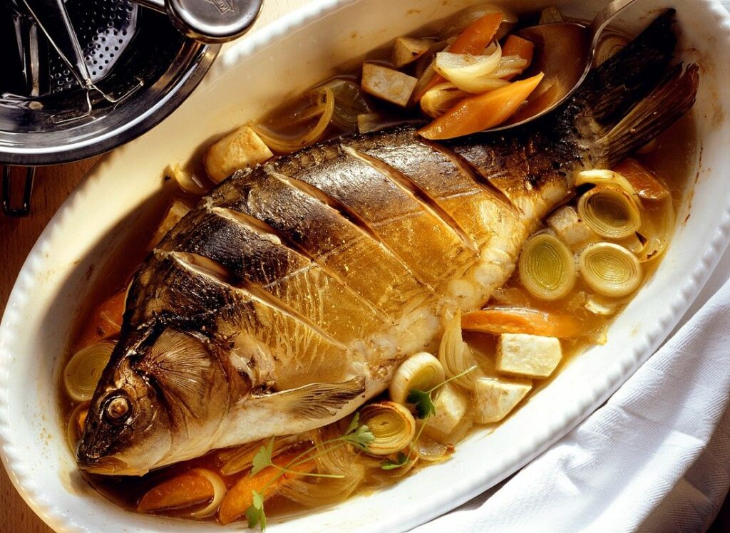 Carp in butter baked in the oven with vegetables.