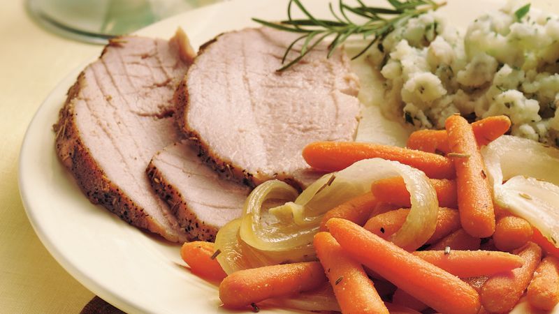 Pork slices on carrots with rosemary