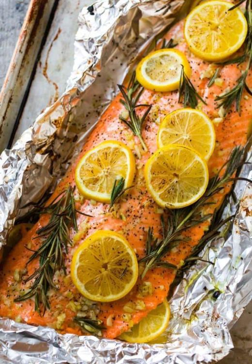 Salmon fillets with herbs and lemon prepared in foil