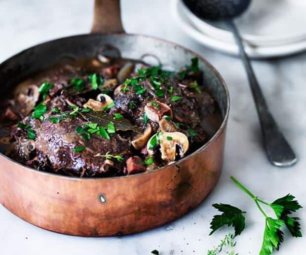 Beef Burgundy style in a pot decorated with fresh parsley