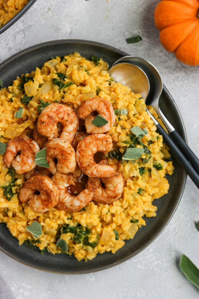 A mixture of rice and pumpkin decorated with tiger prawns