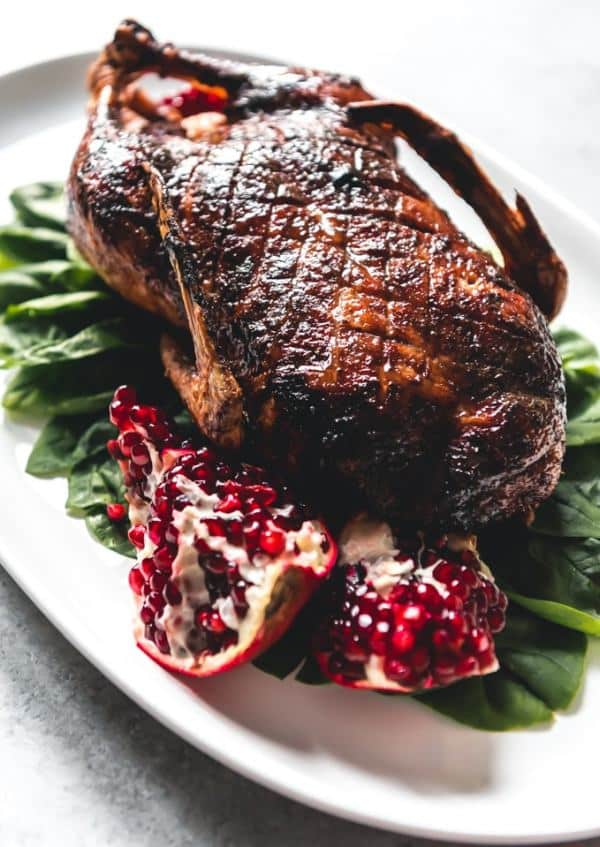 Honey-roasted duck served on a salad leaf with pomegranate