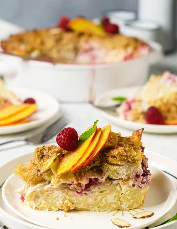 Sweet pasta pudding with cottage cheese, raspberries and peaches