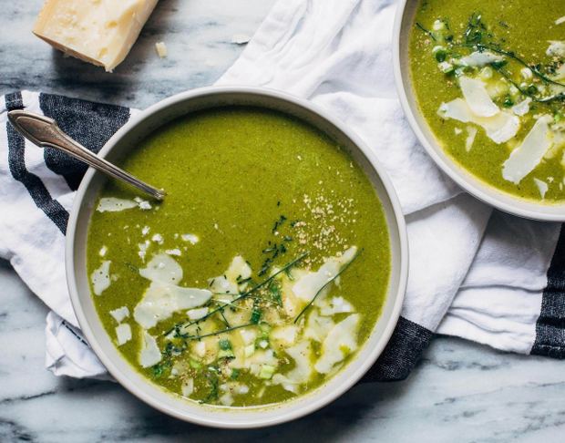A bowl of spring onion soup sprinkled with parmesan cheese