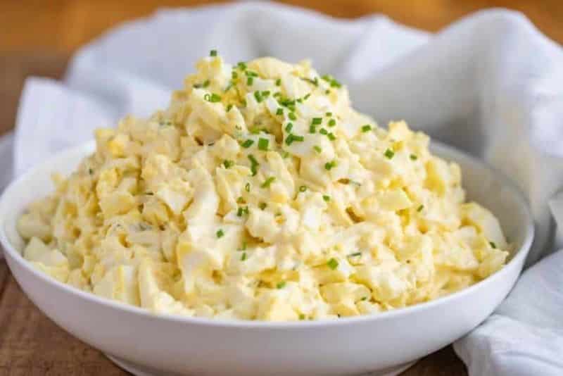 Bowl with a mixture of hard-boiled and chopped eggs, celeriac, mustard and mayonnaise