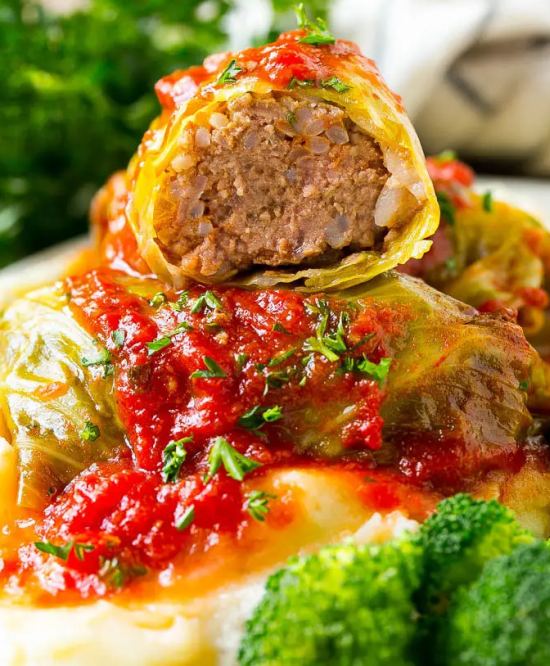 Cabbage leaf rolls filled with minced meat served with tomato sauce