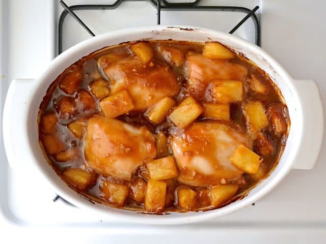 Turkey with pineapple on the stove in a white bowl.