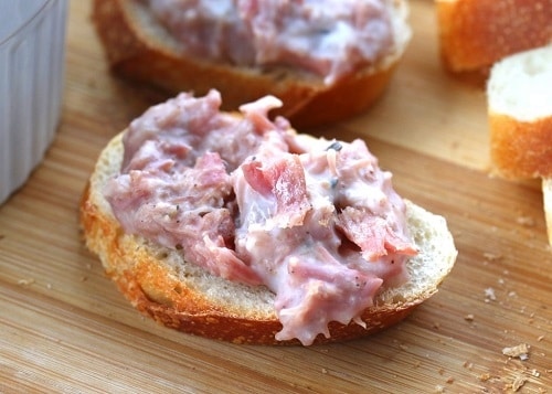 Spread with meat served on a piece of white bread.
