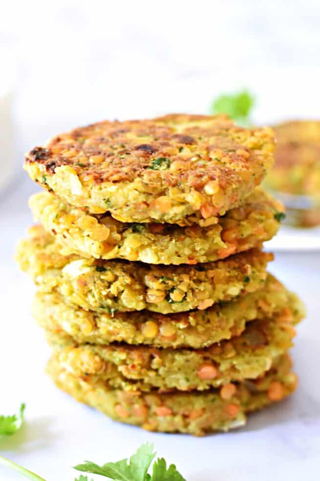 Red lentil and chickpea pancakes stacked on top of each other.