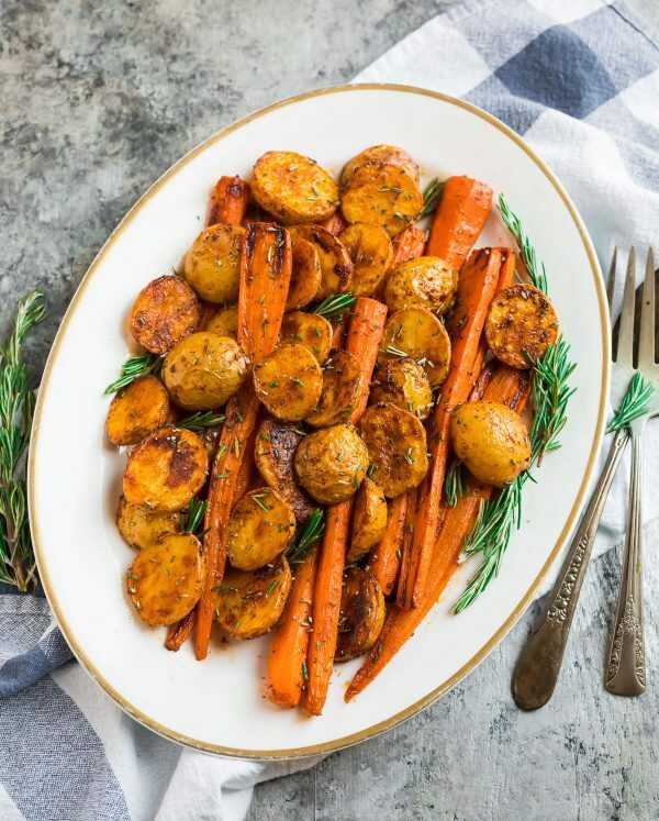 Roasted potatoes and carrots with rosemary on a plate,