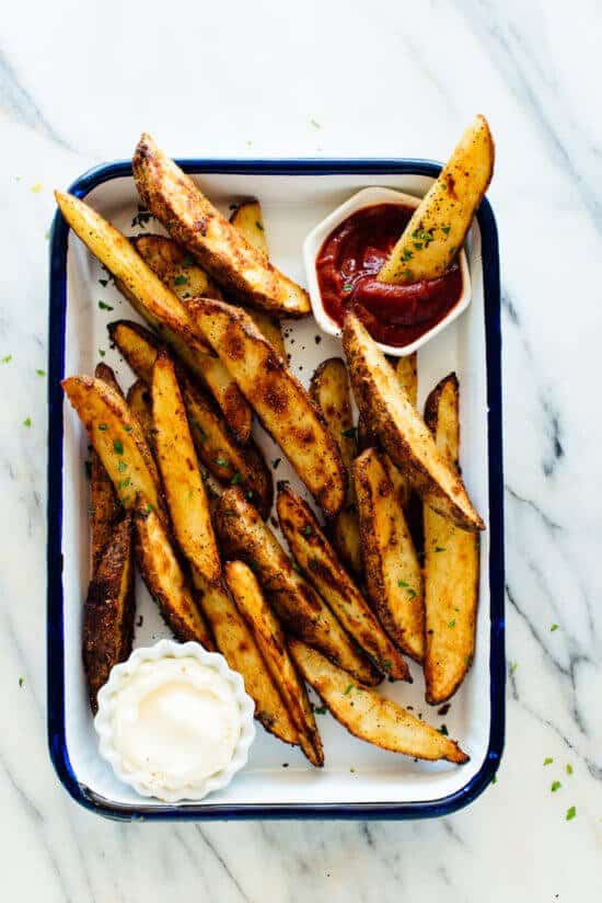 Baked potato wedges in the oven with sauces.