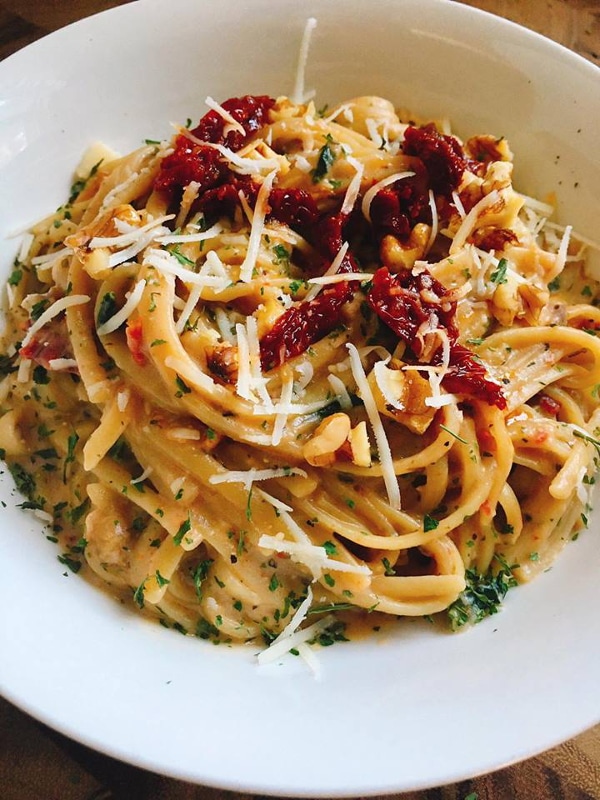 Spaghetti with sun-dried tomatoes and cheese on a plate