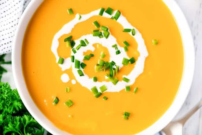 Sweet potato soup served with chives and cream