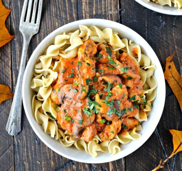 Pasta with chicken meat and mushrooms in paprika sauce