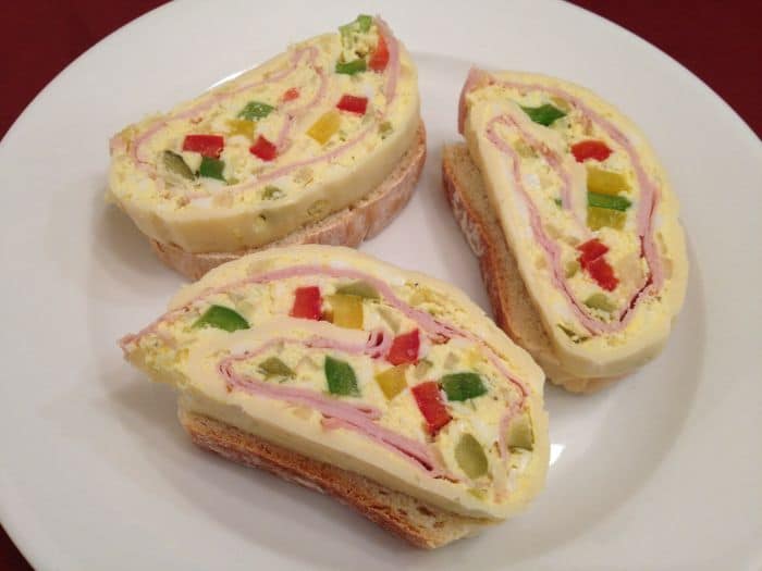 Slices of roulade prepared from cheese, ham and paprika