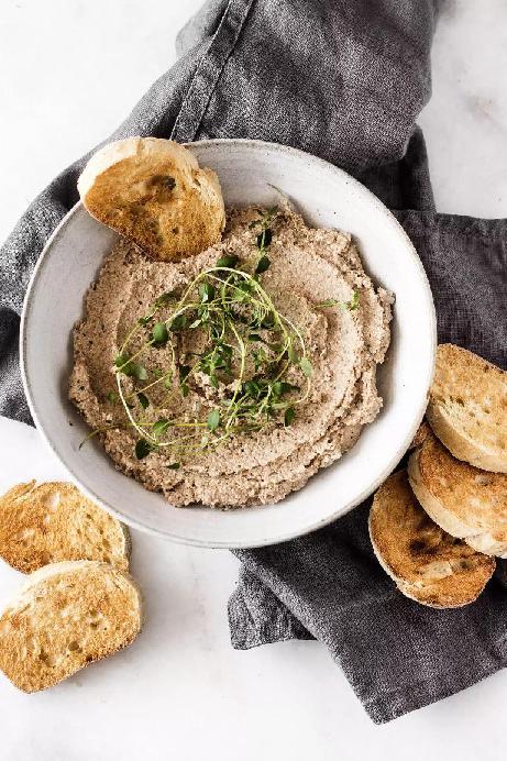 Lentil pate with walnuts served in a bowl with toast.