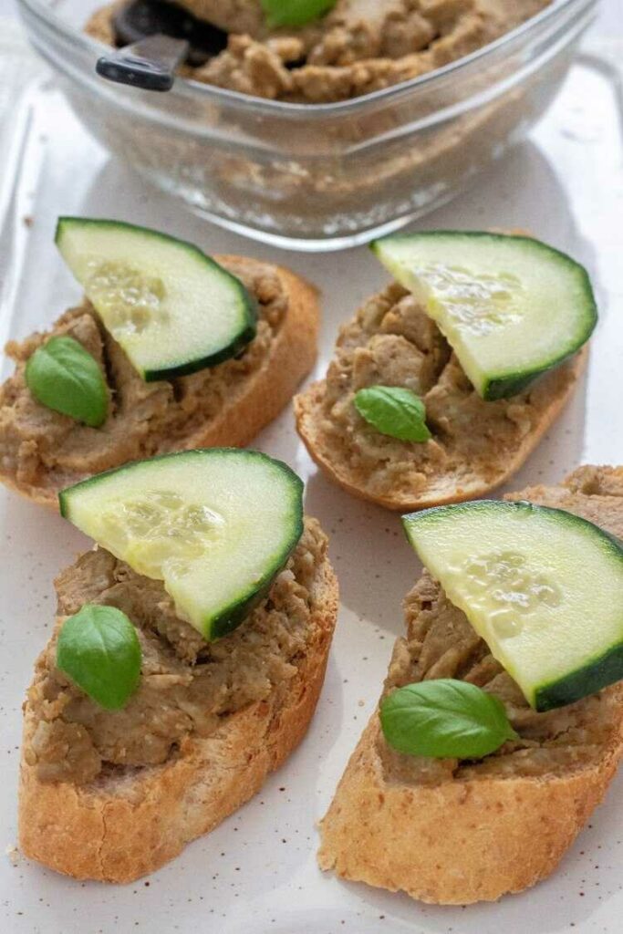 Lentil and mustard spread on baguette slices with cucumber.