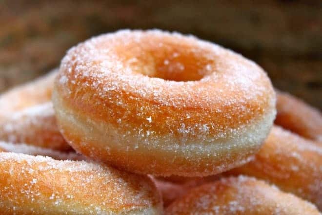 Sweet coated donuts in cinnamon sugar.