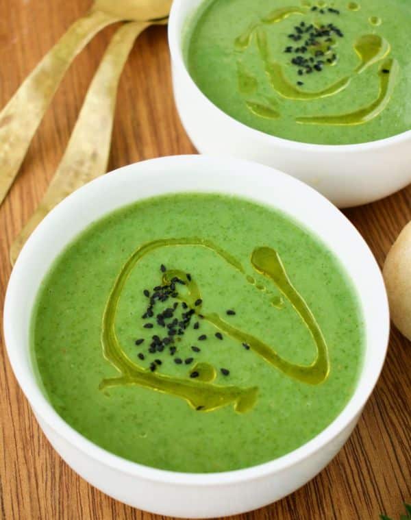 A bowl of nettle soup served with seeds and olive oil