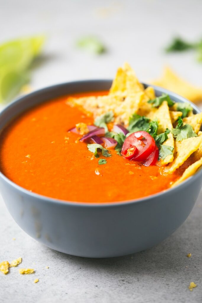 Tomato soup with coconut milk in a blue bowl.