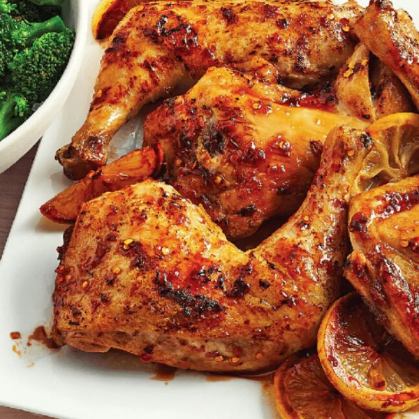 Baked chicken thighs served with oranges