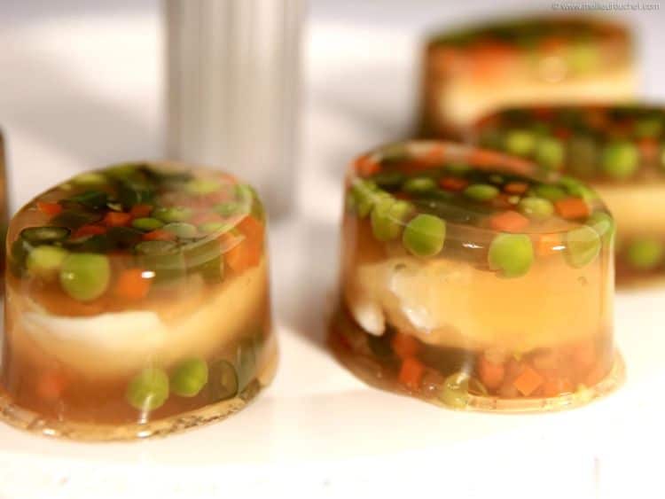 Egg halves with vegetables covered in jelly