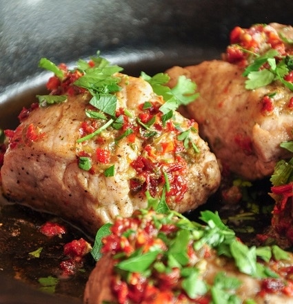 Pork tenderloin with sun-dried tomatoes and fresh parsley.