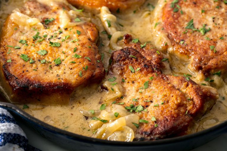 Pork with cream sauce in a pan.