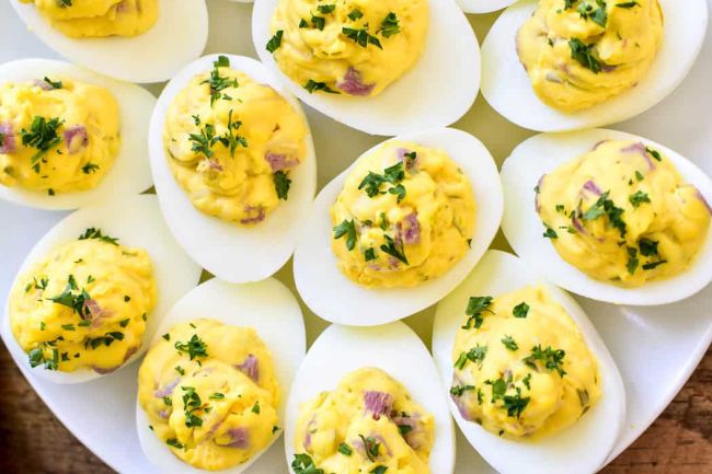 Eggs filled with egg yolk, cheese and ham spread