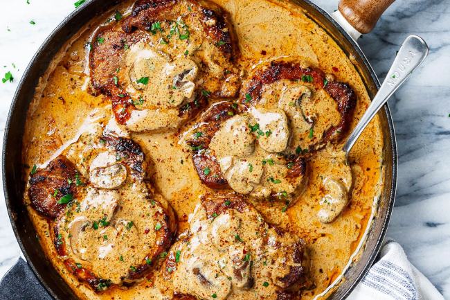 Pork slices with mushrooms in cream and paprika sauce