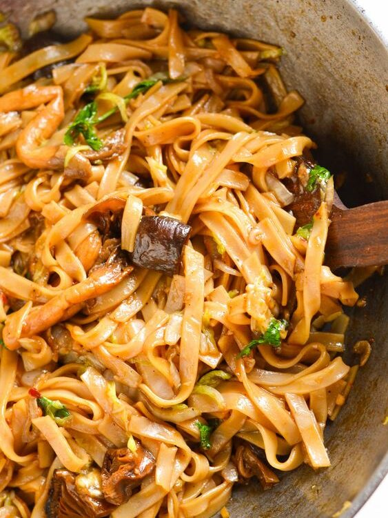 Mushroom noodles with chopped spring onion.