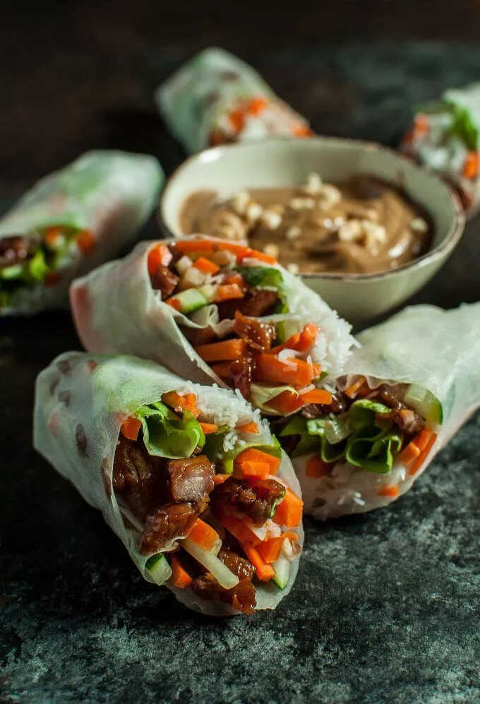 Rice paper rolls filled with vegetables and pork with peanut sauce.