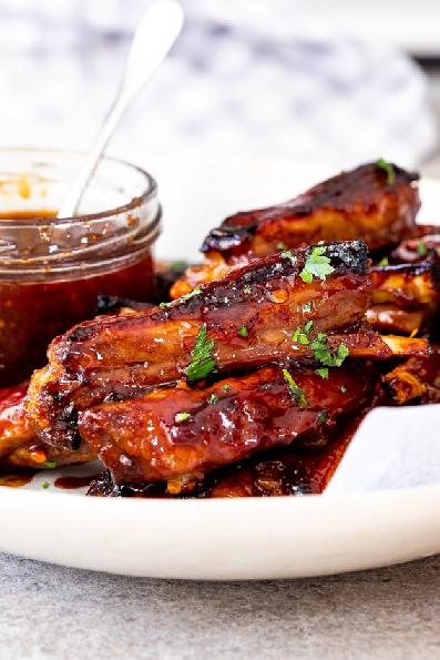 Lamb ribs with marinade served on a plate.