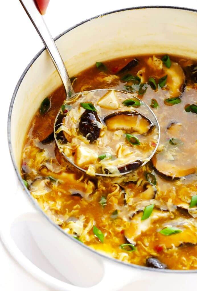 Sweet and sour soup from China with egg and bamboo in a large bowl.