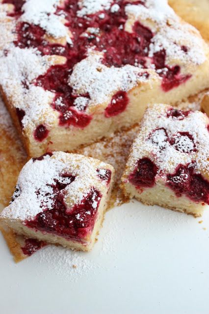 Bun with cherries and sprinkled with powdered sugar.