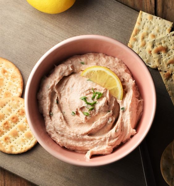 Crackers with fish spread and lemon.